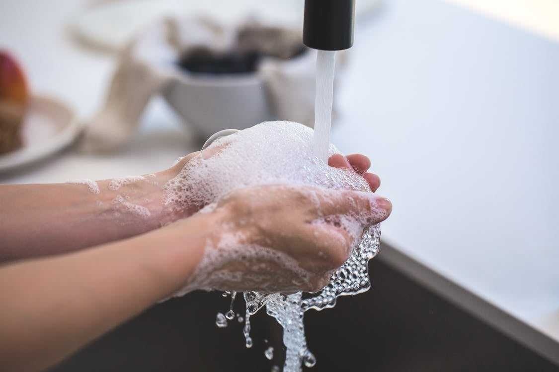 A person washing their hands.